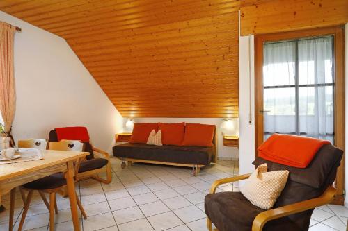 a living room with a couch and a table at Hof Wagenberg Ferienwohnung 2 in Deggenhausertal