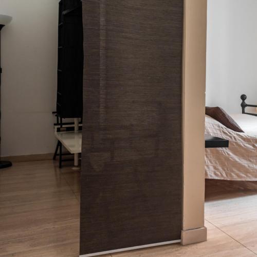 a sliding door in a room with a bed at Arena Alfieri B&B in Livorno