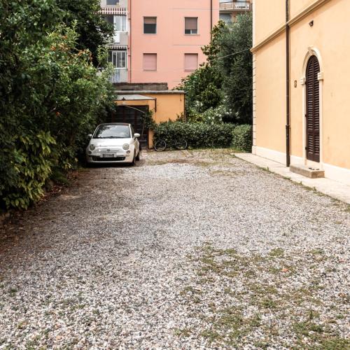 a car parked in a parking lot next to a building at Arena Alfieri B&B in Livorno