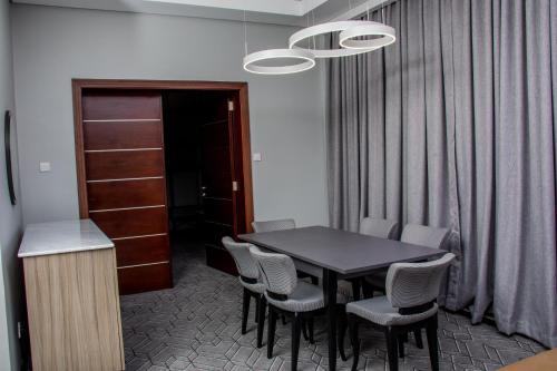a dining room with a black table and chairs at Radisson Lagos Ikeja in Lagos
