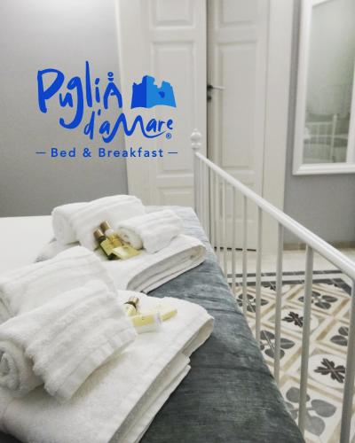 a bedroom with two beds with towels on them at B&B Puglia d'aMare in Lizzano