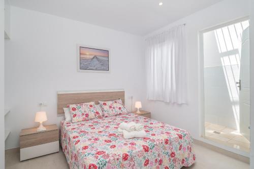 a bedroom with a bed with two towels on it at Aire Siroco - Beach Apartment 13 in Benalmádena