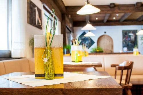 a vase with a plant in it on a table at Christophs Hotel in Schenna