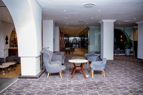 a lobby with chairs and a table in a building at Radisson Lagos Ikeja in Lagos