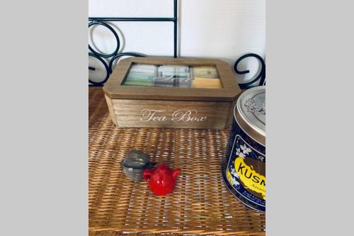 a table with a box and a can of beer and scissors at Bel appartement indépendant centre de Magny-Cours avec parking in Magny-Cours