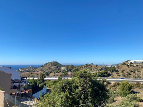 a view of the ocean from a house at Suite Breeze - Private Heated Pool in Málaga