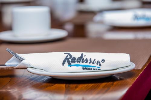a napkin sitting on top of a plate on a table at Radisson Lagos Ikeja in Lagos