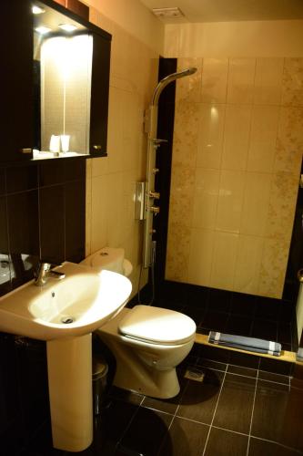 a bathroom with a white toilet and a sink at Sokaki in Méga Khoríon