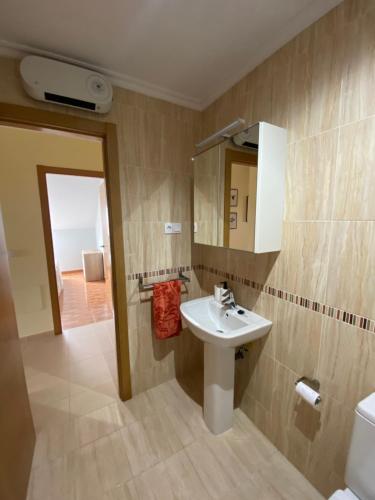 a bathroom with a sink and a mirror at Las Catedrales in Barreiros