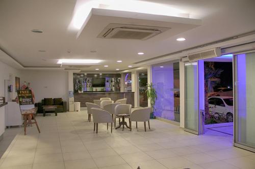 a waiting room with tables and chairs in a building at Club Shark Hotel in Gümbet