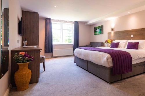 a hotel room with a large bed and a window at The Limes Country Lodge Hotel & Admiral Restaurant in Solihull