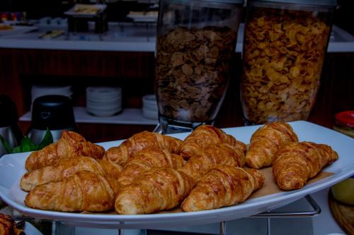 a plate of croissants and other pastries on a table at Radisson Lagos Ikeja in Lagos