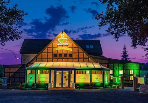 a building with green lights in front of it at Eventhaus Schamin in Erpen