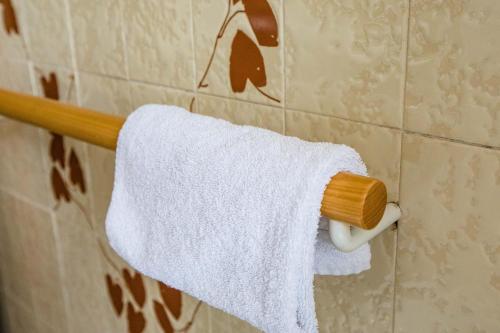 a white towel hanging on a towel rack in a bathroom at Hotel La Tavernetta dei Ronchi in Marina di Massa