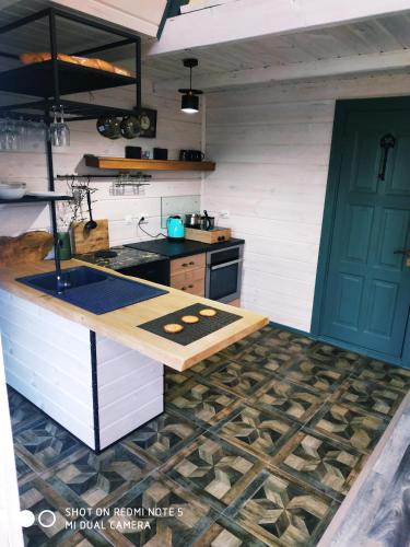 a kitchen with a stove and a counter top at Aframe Shanti DreamDim in Svityazʼ