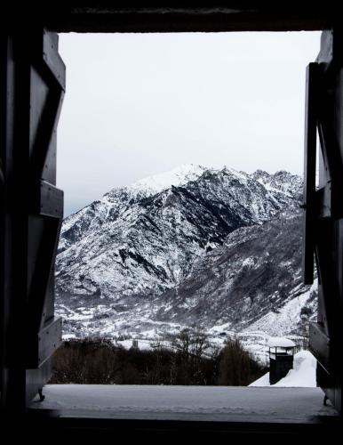 a view of a snow covered mountain from a window at Casa Rural Borda Marianet in Cerler