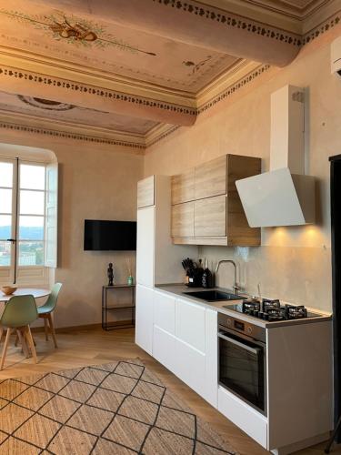 a kitchen with white cabinets and a stove top oven at Corallini Luxury Apartments - Apartment Aka in Cervo