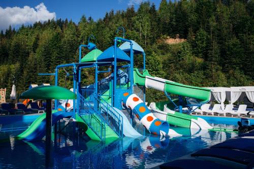 a water park with a water slide in the water at Westhills Cottage Town & Spa in Bukovel