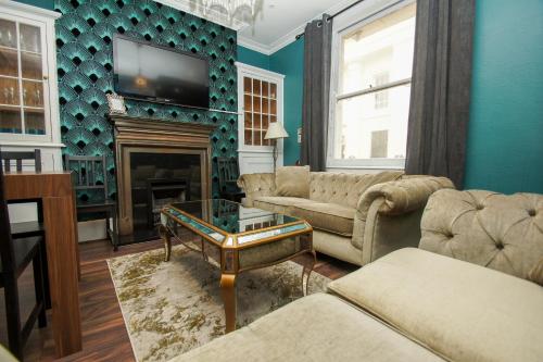 a living room with a couch and a fireplace at Chocolate Box - Central- by Brighton Holiday Lets in Brighton & Hove