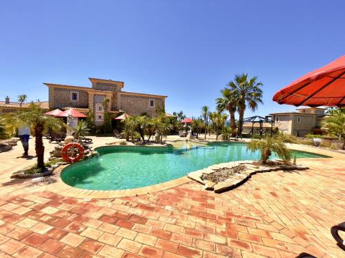 a swimming pool in the middle of a resort at Quinta do Mar - Country & Sea Village in Luz