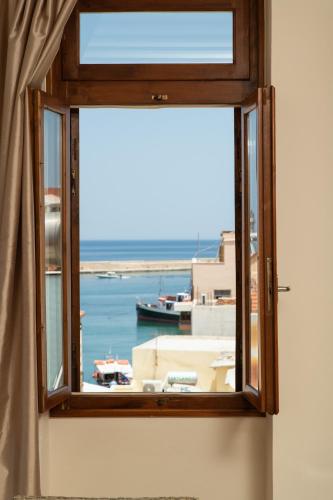 a window with a view of a harbor at Narkissos 'SUPERB' in Chania Town