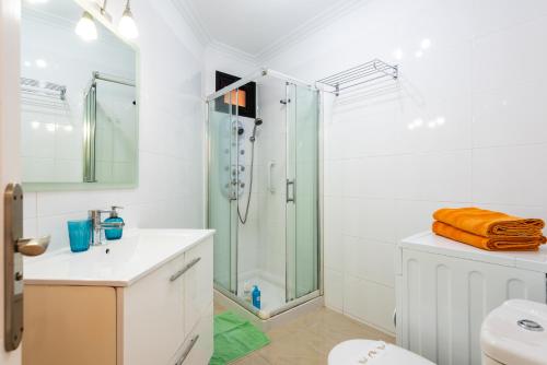 a bathroom with a shower and a toilet and a sink at Tenerife South Apartments in Playa de las Americas