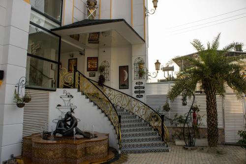 a building with a staircase with a statue in front of it at Sterling Marbella Dehradun in Dehradun