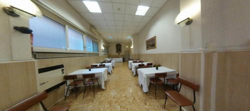 a room with tables and chairs in a restaurant at Casa per Ferie Suore Domenicane in Rome