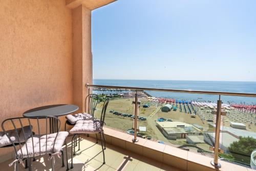 a balcony with a view of a beach and the ocean at Rezident Eforie Nord in Eforie Nord