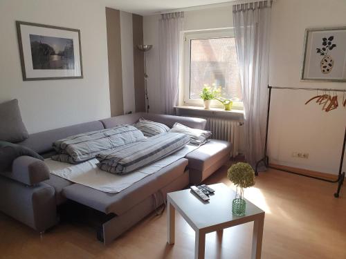 a living room with a couch and a table at Ferienwohnung Baumann in Neupotz