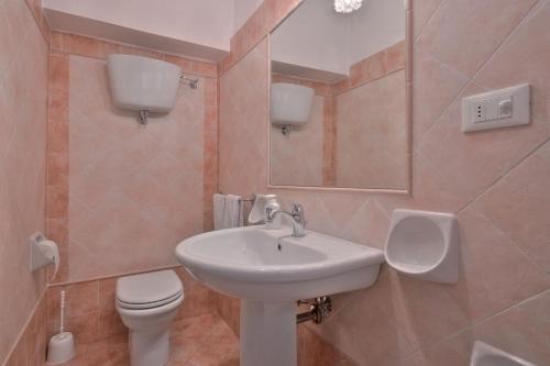 a bathroom with a sink and a toilet and a mirror at Castello di Sarna in Chiusi della Verna