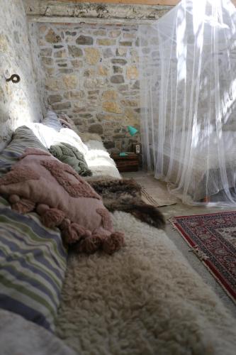a group of pillows on a bed in a room at Dejavu Ház in Szentantalfa
