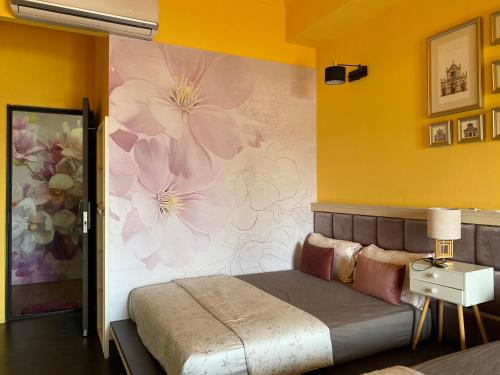 a bedroom with a large flower mural on the wall at Teacher Cai Homeestay in Xiaoliuqiu