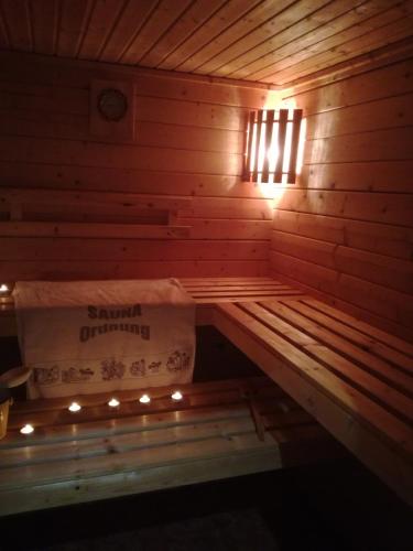 a wooden sauna with a box and a light at Ferienwohnung Tuchscherer in Cranzahl