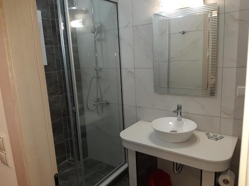 a bathroom with a shower and a sink and a showerspective at Villa Pappas in Parga