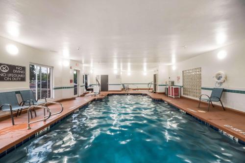 a swimming pool with blue water in a building at Sleep Inn Flagstaff in Flagstaff