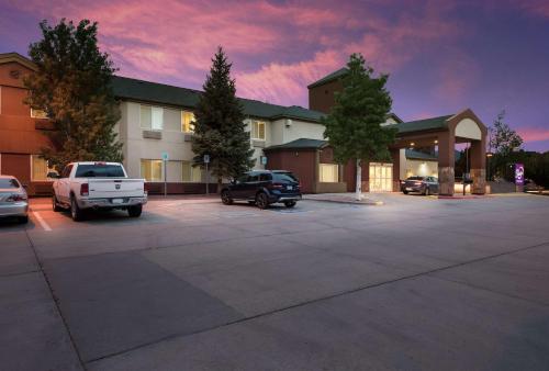 a building with cars parked in a parking lot at Sleep Inn Flagstaff in Flagstaff