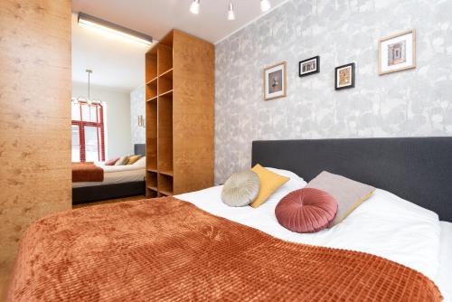 a bedroom with a bed with pillows on it at Stylish apartment with parking in Telliskivi in Tallinn