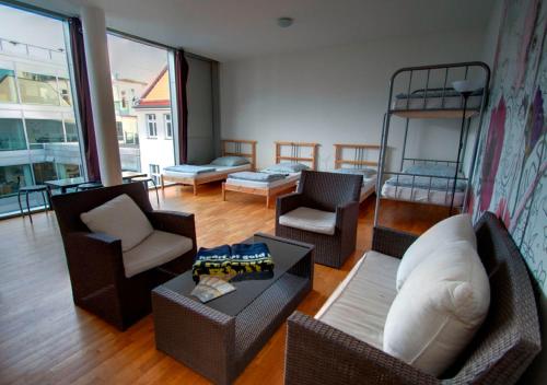 a living room with furniture and a bunk bed at Heart of Gold Hostel Berlin in Berlin