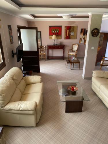 a living room with a couch and a piano at Softades Cottage in Omodos