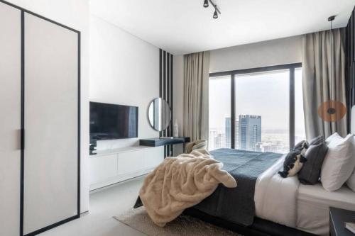 a bedroom with a bed and a large window at The Smart Concierge - Address JBR in Dubai