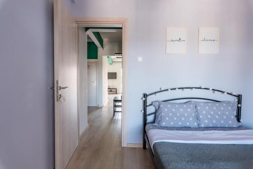 a bedroom with a bed and a hallway at Cozy apartment next to city center in Thessaloniki