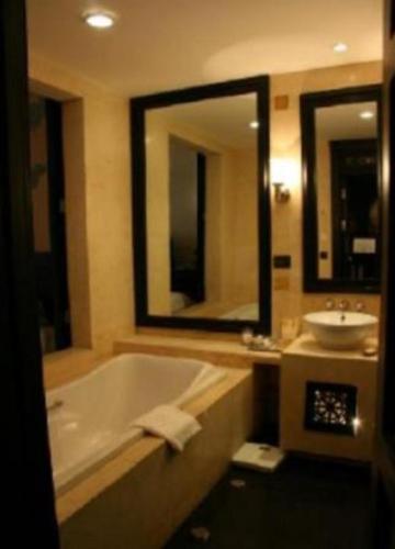 a bathroom with a bath tub and a sink at Pemako in Thimphu
