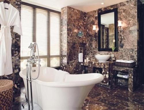 a large bathroom with a tub and a sink at Pemako in Thimphu
