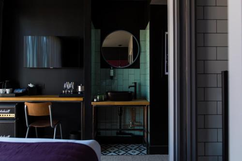 a bathroom with a sink and a mirror on the wall at The Baltic Hotel in Liverpool