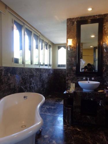 a bathroom with a bath tub and a sink at Pemako in Thimphu