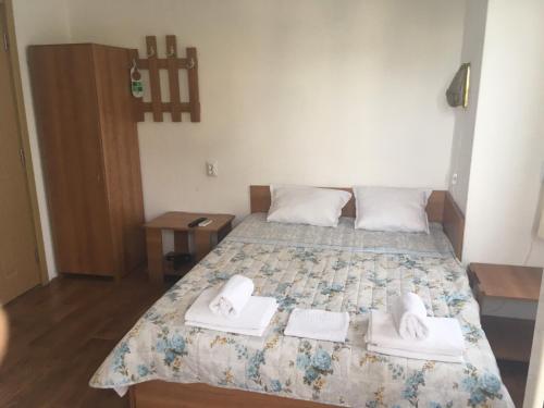 a bedroom with a bed with towels on it at Hris in Chernomorets