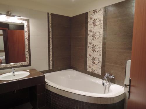 a bathroom with a bath tub and a sink at Penzion U Císaře Zikmunda in Znojmo