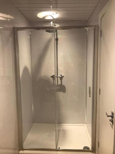 a shower stall with a glass door in a bathroom at The Wellington House Hotel in Blackpool