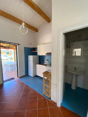 a large kitchen with a sink and a counter at Vivilo Collection - Chalet Mare - Private parking - Just 50 meters from the beach in Sperlonga